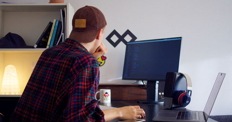 Guy sitting as his desk thinking really hard